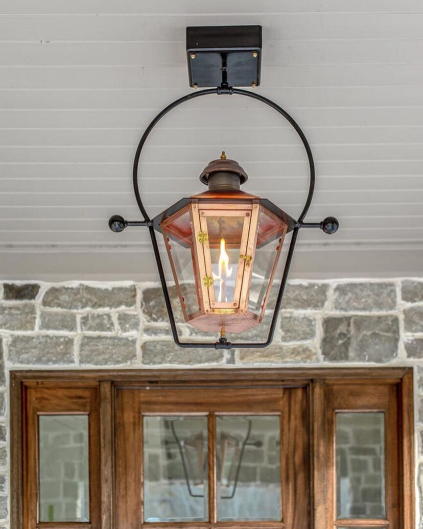 A lantern hanging from the ceiling of a house.